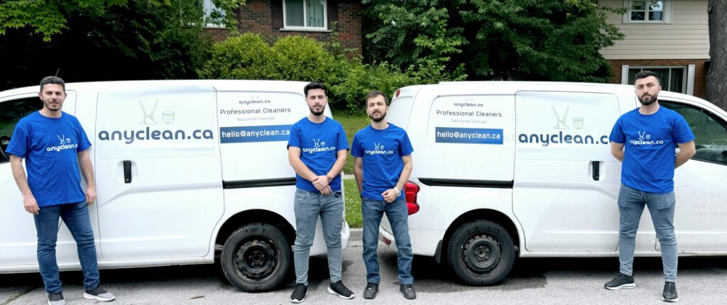 AnyClean cleaning services in Prince Albert, Saskatchewan: cleaners beside two service vans