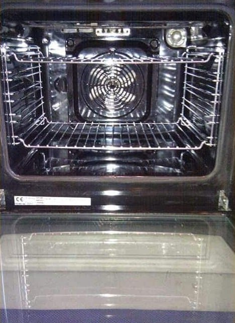 The same oven after AnyClean professional oven cleaning: degreased cavity, shining racks and streak-free door glass